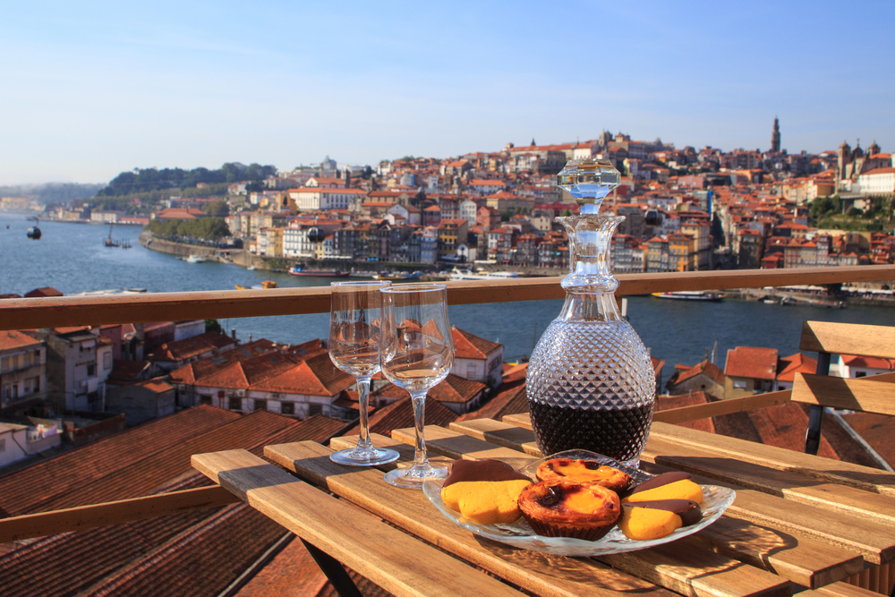 View of Portugal from a table with port and pastel de nata