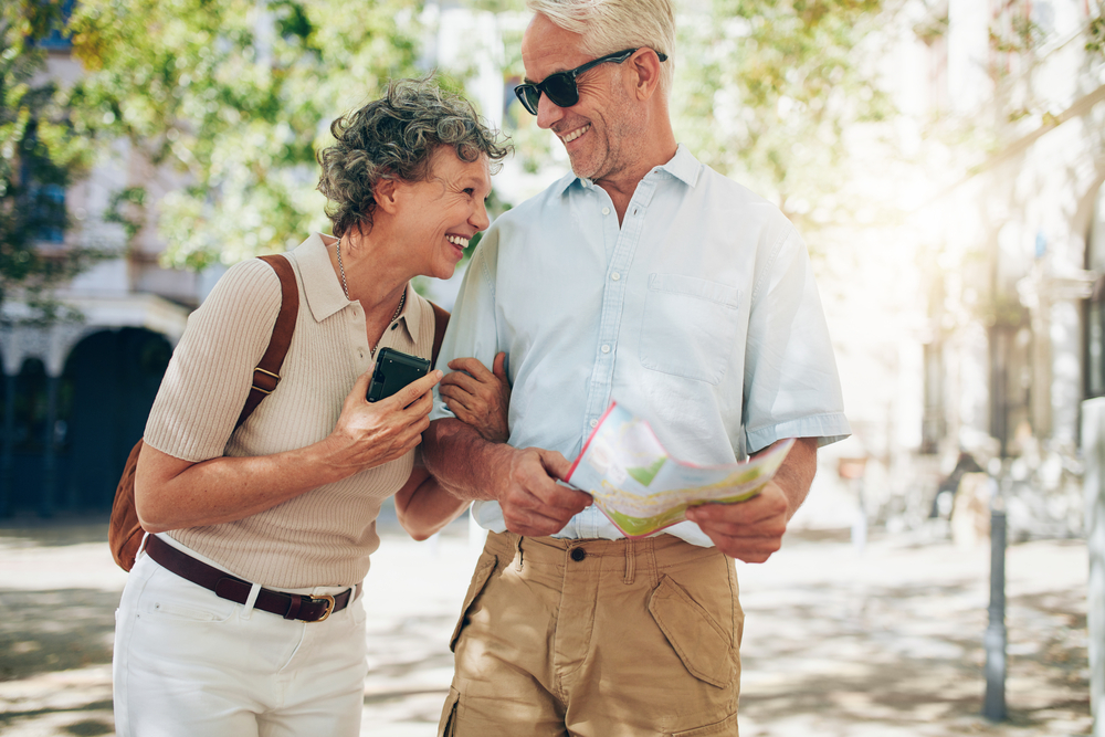 a couple traveling on a bright day with good retirement plan map
