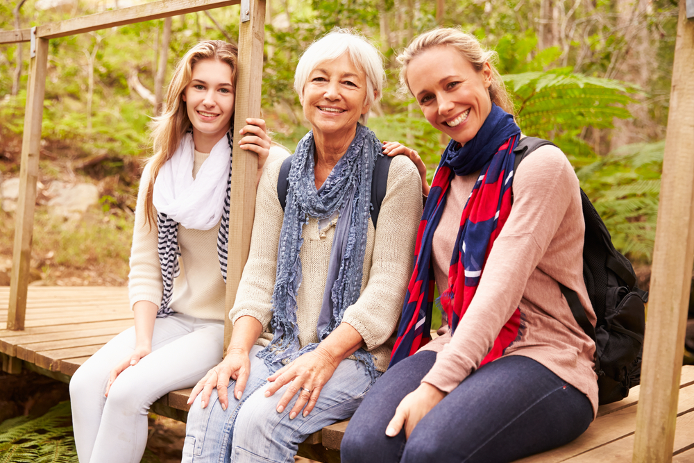 Three generations of women on a bridge talking about women and finances.