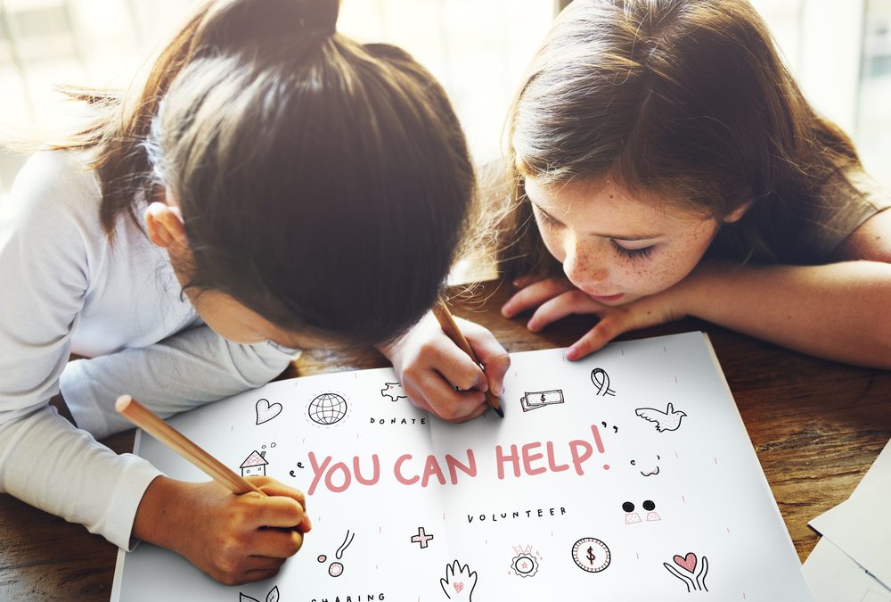 two kids drawing a picture that says you can help support charitable organizations