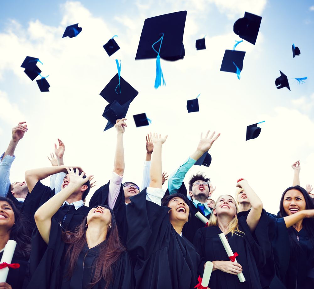 students throw their hats after using college savings plan to graduate